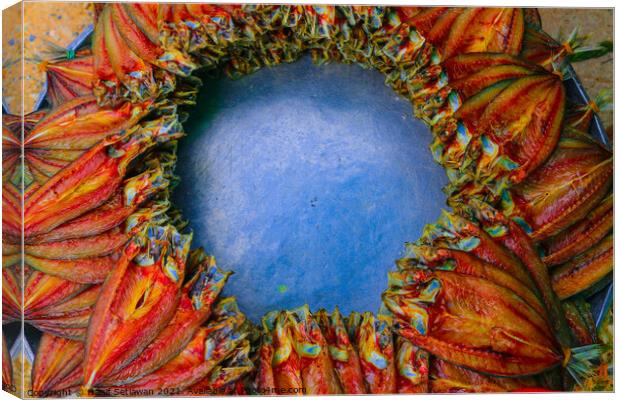 Salted fish offered on a street market in a decorative circle. Canvas Print by Hanif Setiawan