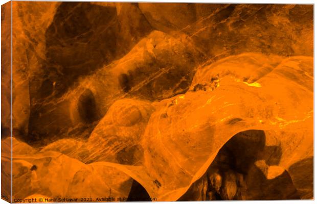 Abstract shapes on a flowing stone wall in a cave Canvas Print by Hanif Setiawan