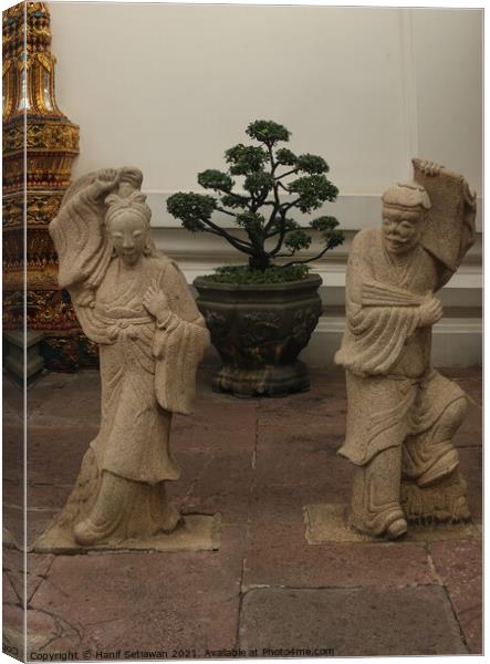 Stone sculptures art from Asian woman and man. Canvas Print by Hanif Setiawan
