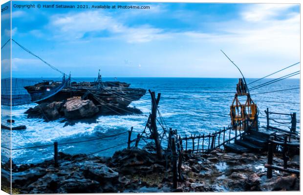 Swinging rope foot bridge and cable car to a rock  Canvas Print by Hanif Setiawan