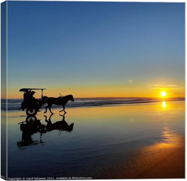 Horse-drawn carriage on sunset beach in square 1 Canvas Print by Hanif Setiawan