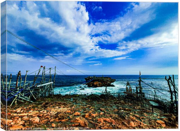 A rock plateau and a rock island in the sea 3 Canvas Print by Hanif Setiawan