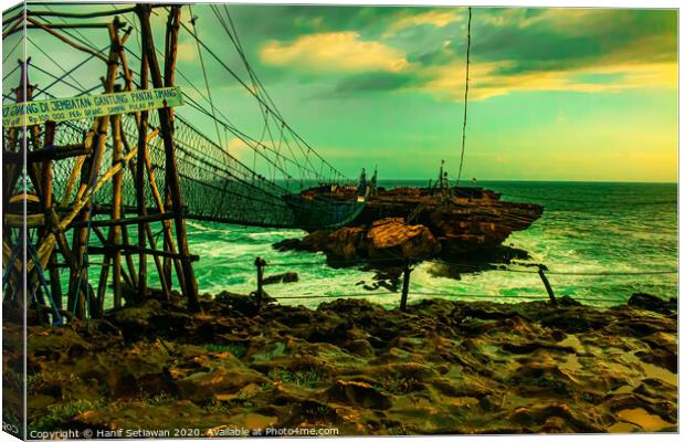 Challenge on a rope foot bridge to a rock island. Canvas Print by Hanif Setiawan
