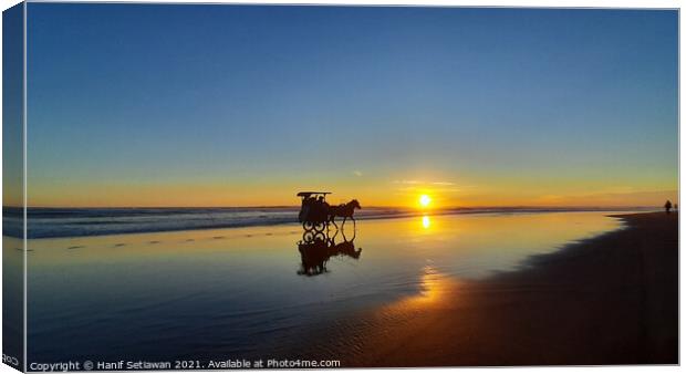 Silhouetted horse-drawn carriage beach sunset 4 Canvas Print by Hanif Setiawan