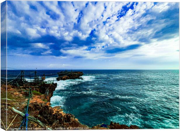 A rock plateau and a rock island in the sea Canvas Print by Hanif Setiawan