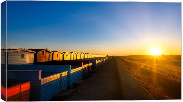 Sunset over the Walings beach huts Frinton-on-Sea Canvas Print by Paula Tracy