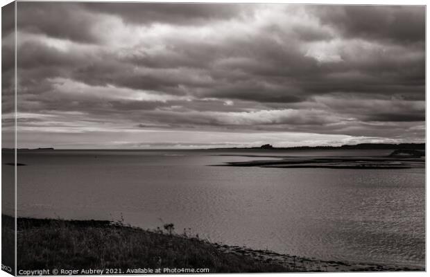 Bamburgh Castle from Holy Island Canvas Print by Roger Aubrey