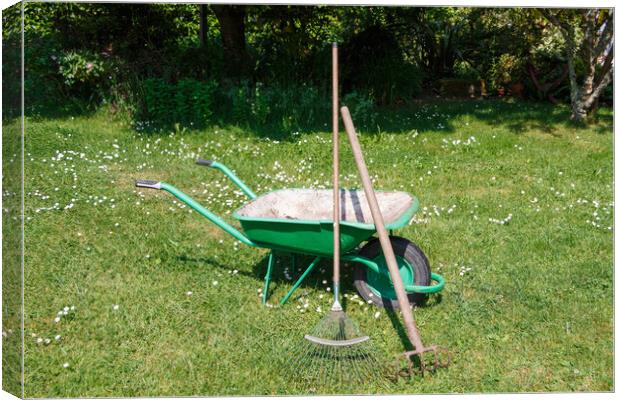Wheelbarrow with lawn rake and claw cultivator Canvas Print by aurélie le moigne