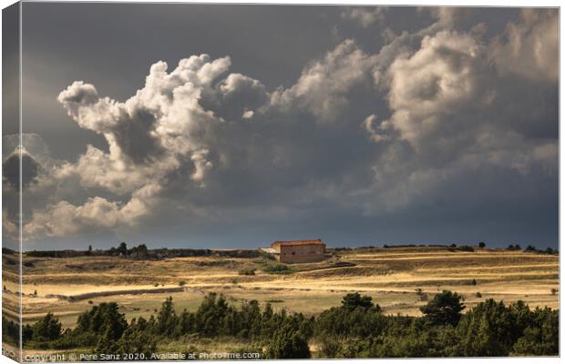 Stormy Clouds over a rural House  Canvas Print by Pere Sanz