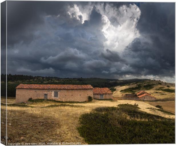 Dramatic Stormy Clouds over Abandoned Rural Houses Canvas Print by Pere Sanz