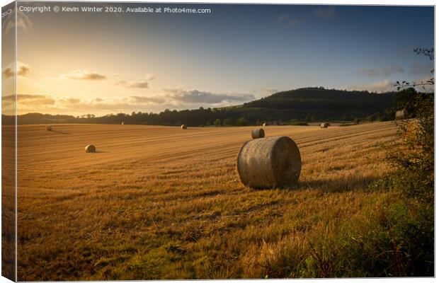 Sunset haybales Canvas Print by Kevin Winter