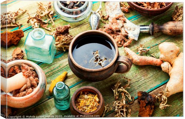 Herbal tea on old wooden table Canvas Print by Mykola Lunov Mykola