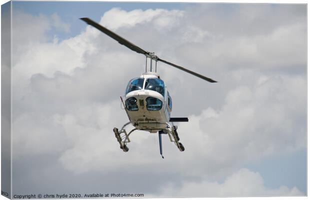 helicopter under cumulous clouds Canvas Print by chris hyde