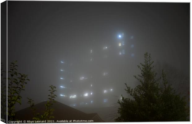Eerie sky scraper hospital lights shine through very thick fog. Canvas Print by Rhys Leonard
