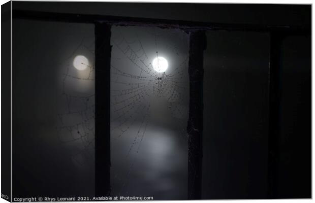 Spooky night time fog around a cobweb under railings with dew on it Canvas Print by Rhys Leonard