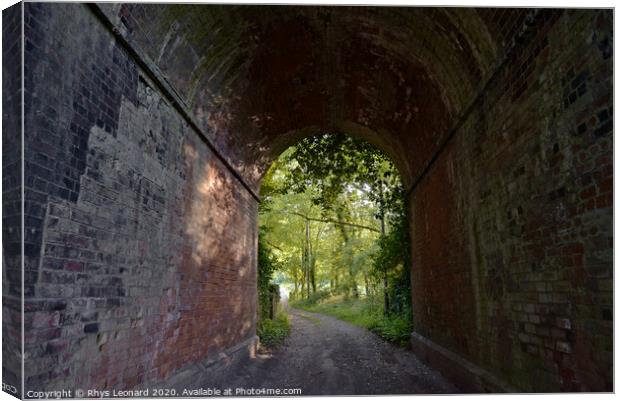 Red brick tunnel contains a muddy double-track lane Canvas Print by Rhys Leonard