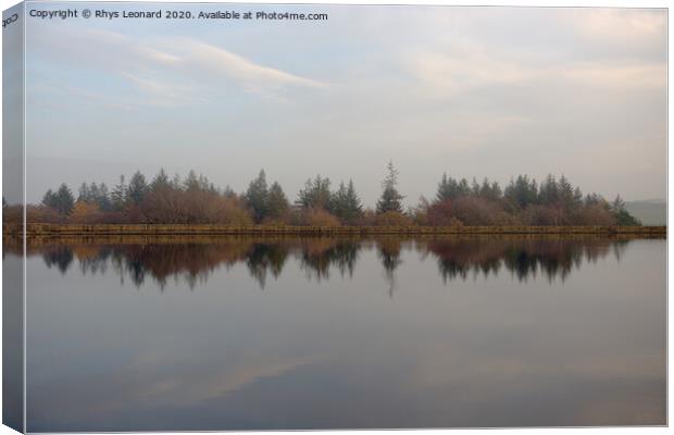 Dim evening light reflects autumn trees and redmires reservoir wall. Canvas Print by Rhys Leonard
