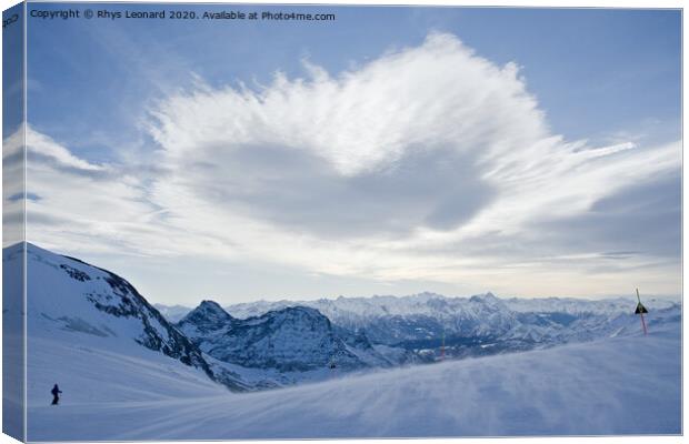 Blue alps landscape, from the top of a ski run. Canvas Print by Rhys Leonard