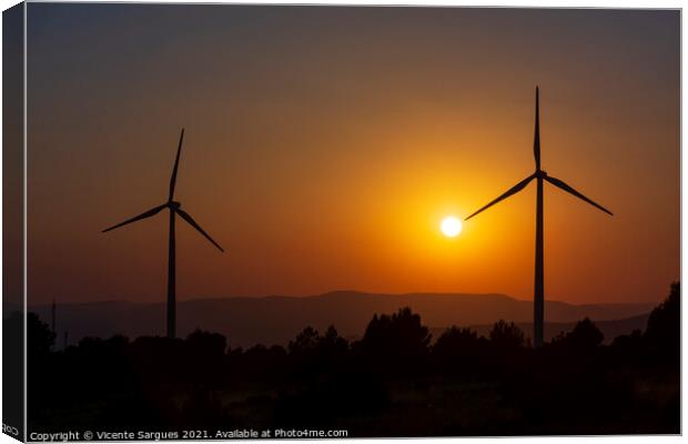 Two windmills facing the sun at sunset Canvas Print by Vicente Sargues