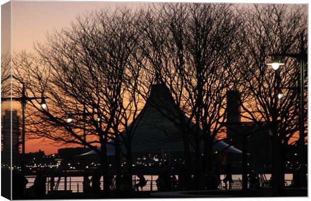 NYC pier sunset through the trees Canvas Print by Yulia Vinnitsky