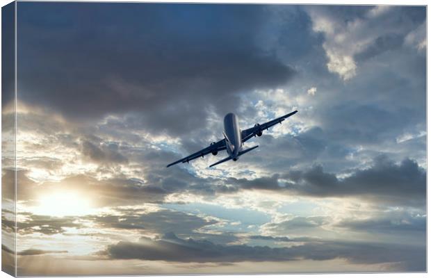 Passenger airplane on a cloudy sky Canvas Print by Arpad Radoczy