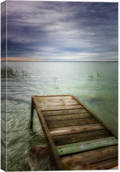 Wooden pier in lake Balaton of Hungary in a cloudy Canvas Print by Arpad Radoczy
