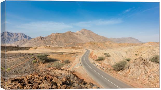 A road going thru the deserted mountains of Oman Canvas Print by David GABIS
