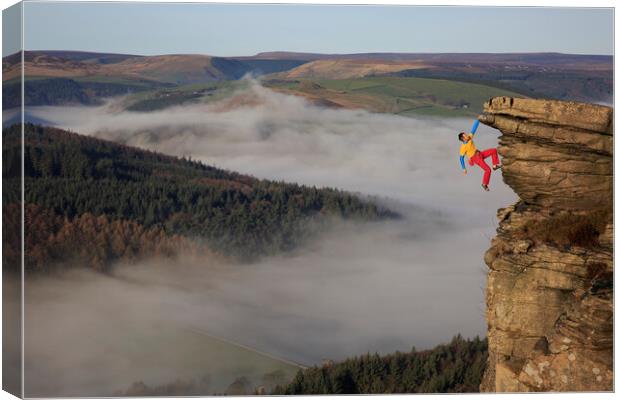 A rock climber free climbing on bamford edge in th Canvas Print by MIKE HUTTON