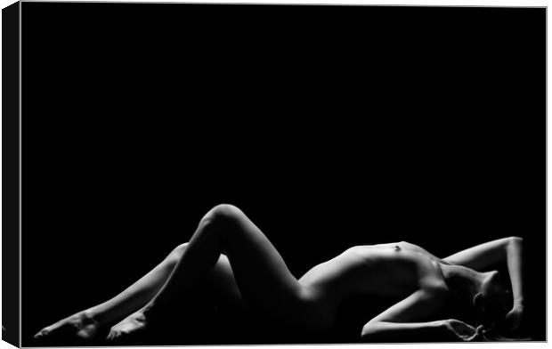 a woman nude and naked in fine art photography bodyscape laying on black studio background Canvas Print by Alessandro Della Torre