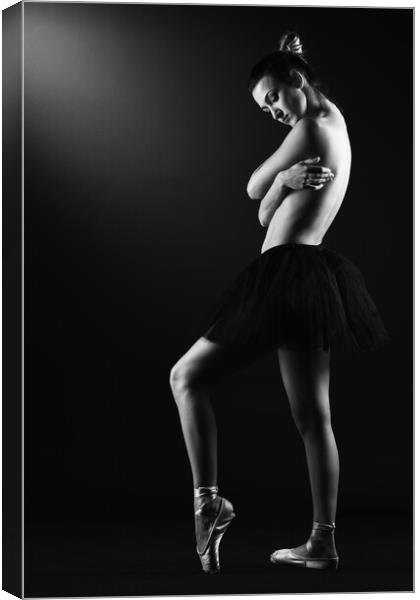 A classic ballerina ballet dancer woman in a classical tutu dress posing on black Canvas Print by Alessandro Della Torre