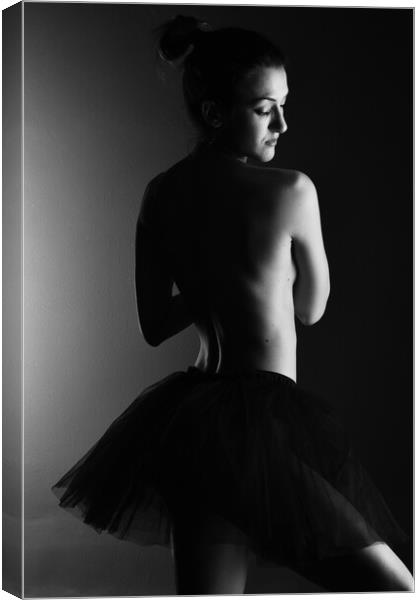A classic ballerina ballet dancer woman in a classical tutu dress posing on black Canvas Print by Alessandro Della Torre
