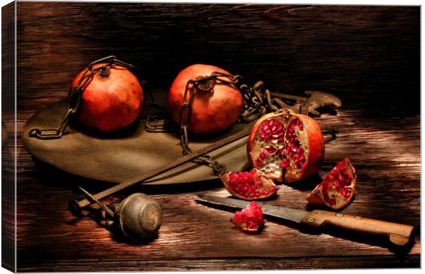 Pomegranates on a wooden table Canvas Print by Alessandro Della Torre