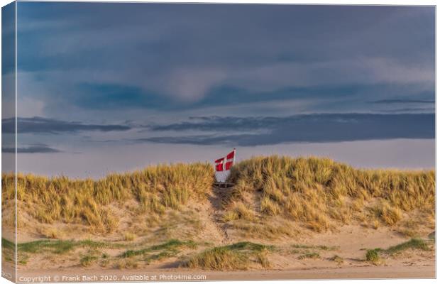 Danish flag waving behind dunes on Blaavand Beach, Denmark Canvas Print by Frank Bach