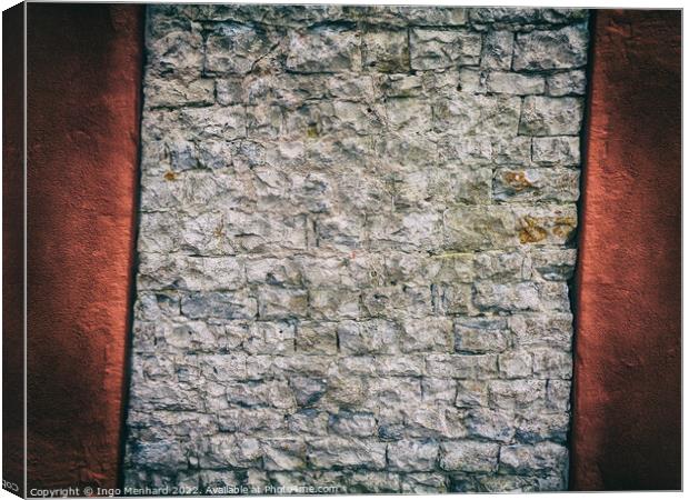 Crooked and abstract old brick wall between red concrete Canvas Print by Ingo Menhard