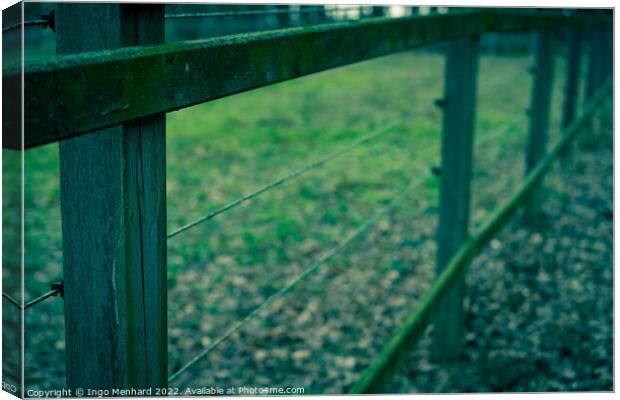 Low angle shot of an old wooden fence in a field at dawn in autumn Canvas Print by Ingo Menhard
