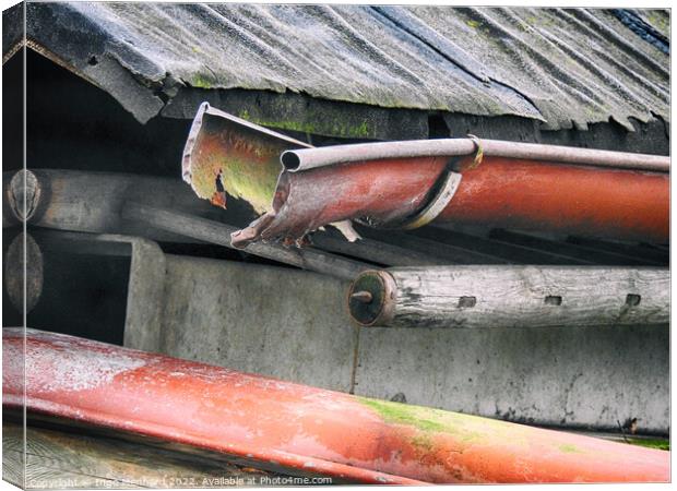 Closeup shot of a rusty pipe under the weathered roof Canvas Print by Ingo Menhard