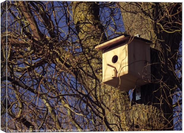 Scenic shot of a wooden birdhouse hanging from a tree Canvas Print by Ingo Menhard