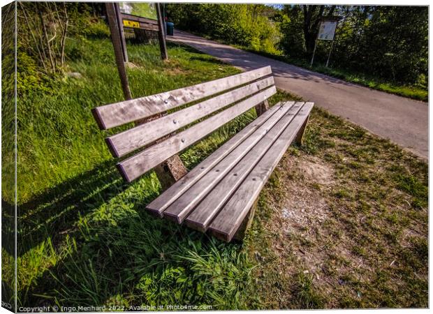 High angle shot of a bench near a street Canvas Print by Ingo Menhard