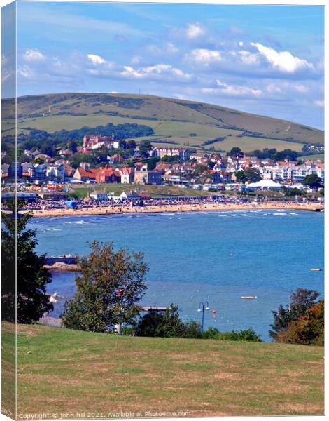 Bay and beach in portrait, Swanage, Dorset, UK. Canvas Print by john hill
