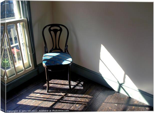 Chair in a empty room. Canvas Print by john hill
