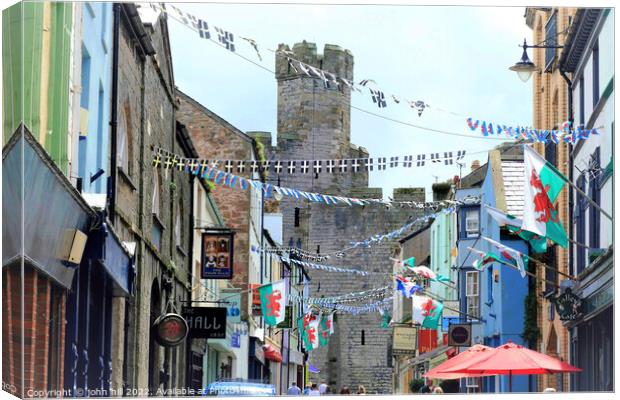 Flags and bunting, Caernarfon, North Wales, UK. Canvas Print by john hill