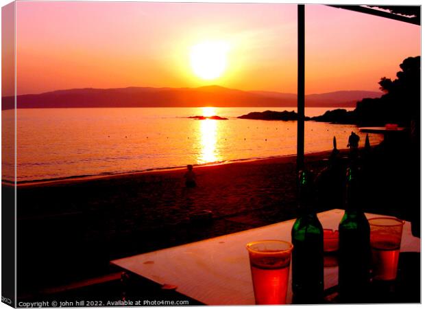 Sunset across the sea at Agia Eleni beach Skiathos, Greece. Canvas Print by john hill