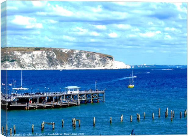 Echoes of Time: Swanage's Historic & Modern Piers Canvas Print by john hill