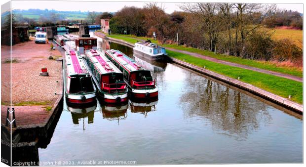 Barges and narrow boats berthed . Canvas Print by john hill