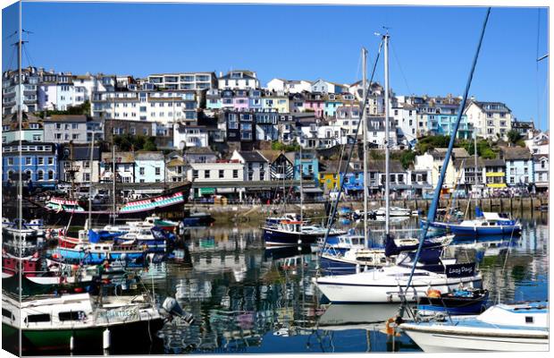 The inner harbour with reflections at Brixham in Devon. Canvas Print by john hill
