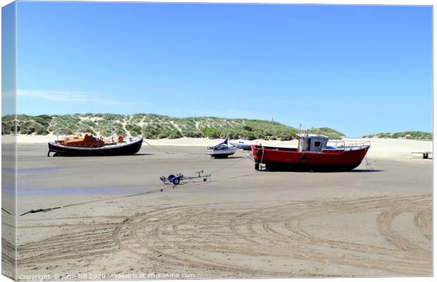 Beached boats on the beach at Barmouth in Wales. Canvas Print by john hill