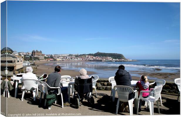 Tourists enjoying the view of Scarborough over the bay at low tide Canvas Print by john hill