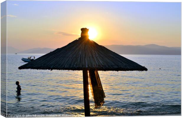 Sunset at Ag Eleni beach on Skiathos in Greece. Canvas Print by john hill