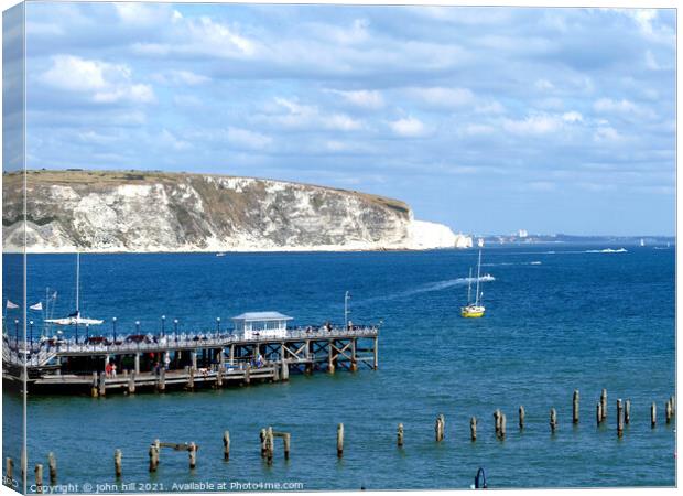Old  & New piers at Swanage in Dorset. Canvas Print by john hill