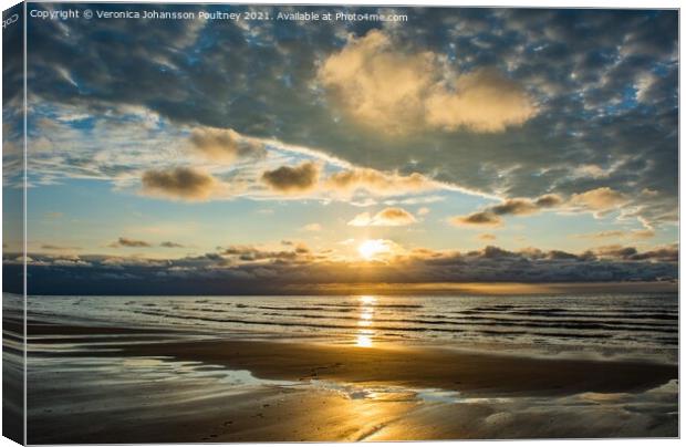 A sunset over a beach in Norfolk Canvas Print by Veronica in the Fens